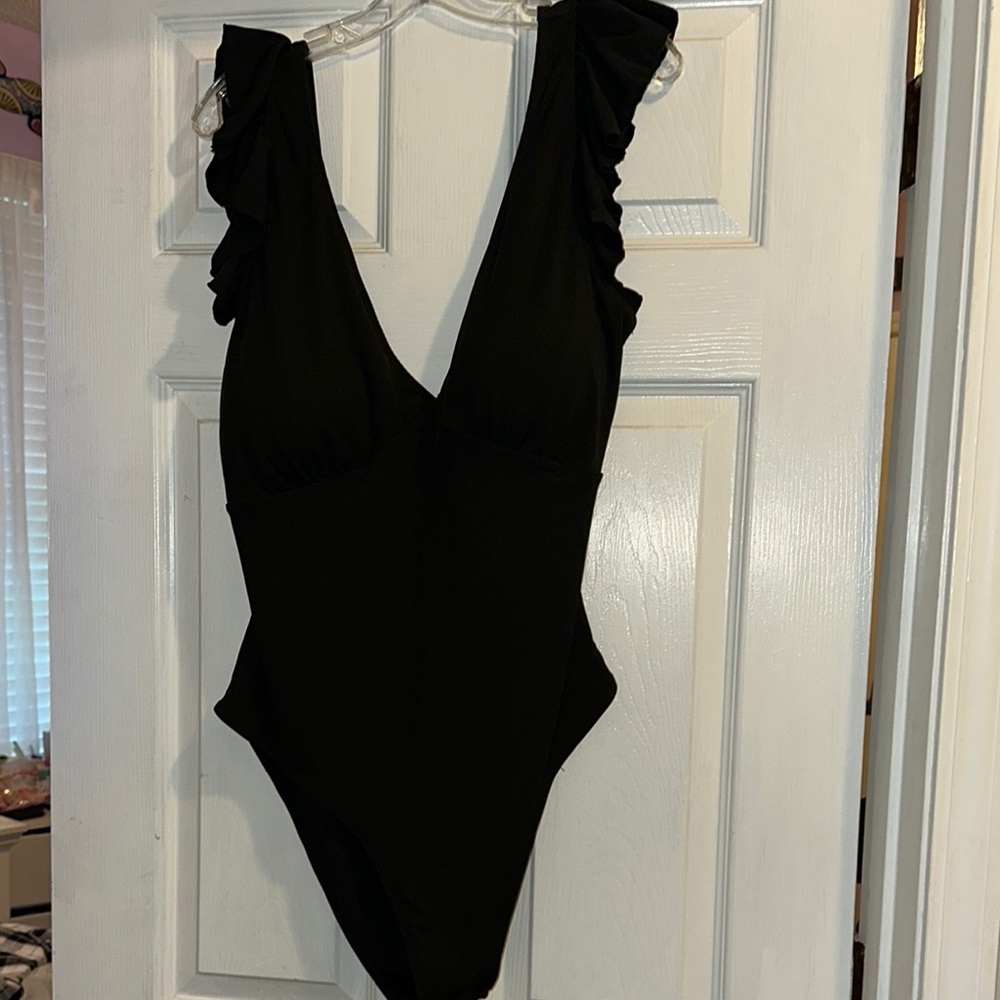 Black ruffle sleeved swim suit.